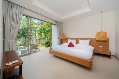a bedroom with a bed and a large window at 3 Bedroom Villa with Private pool in Laguna Phuket