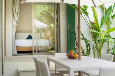 a dining room with a table and a bed at 3 Bedroom Villa with Private pool in Laguna Phuket