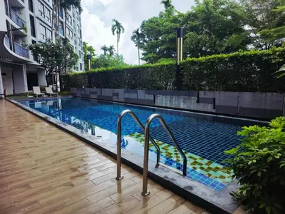 a swimming pool with two metal rails next to a building at Vista Old Town Phuket in Phuket Town