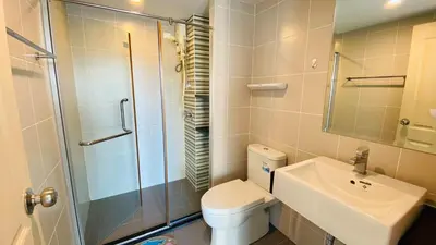 a bathroom with a toilet and a sink and a shower at Vista Old Town Phuket in Phuket Town