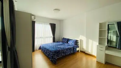 a small bedroom with a bed and a window at Vista Old Town Phuket in Phuket Town