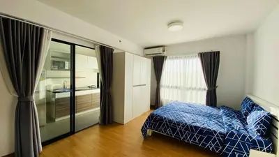 a small bedroom with a bed and a bathroom at Vista Old Town Phuket in Phuket Town