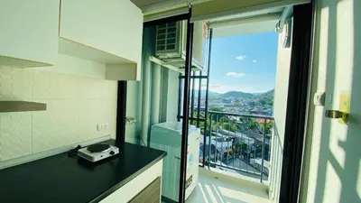 a bathroom with a balcony with a view of a city at Vista Old Town Phuket in Phuket Town