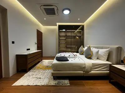 a bedroom with a bed and a dresser in it at The Nature Villa Phuket in Rawai Beach