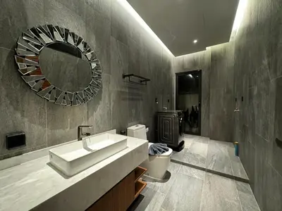 a bathroom with a sink and a mirror and a toilet at The Nature Villa Phuket in Rawai Beach