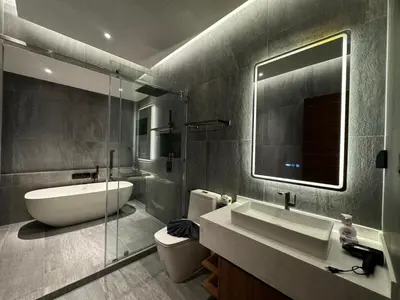 a bathroom with a sink and a toilet and a mirror at The Nature Villa Phuket in Rawai Beach
