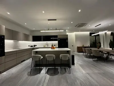 a kitchen with a island and a table and chairs at The Nature Villa Phuket in Rawai Beach