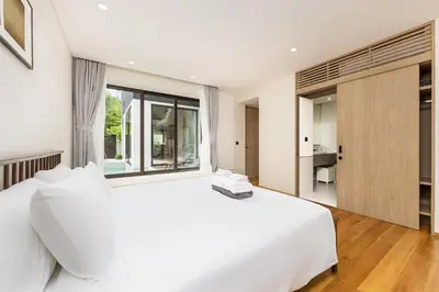 a white bedroom with a large bed and a window at Qabalah 2BR Villa Pool Rooftop Near Bangtao by TropicLook in Bang Tao Beach
