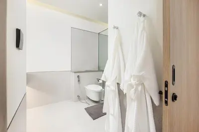 a white bathroom with a toilet and a shower at Qabalah 2BR Villa Pool Rooftop Near Bangtao by TropicLook in Bang Tao Beach