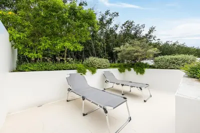 two chairs and a bench on a white wall at Qabalah 2BR Villa Pool Rooftop Near Bangtao by TropicLook in Bang Tao Beach