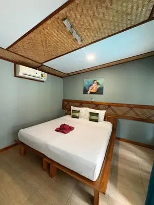 a bedroom with a large white bed in a room at Phi Phi Ingphu Viewpoint Hotel in Phi Phi Don