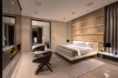 a bedroom with a bed and a desk and a chair at Cliff Top Residence in Phuket Town