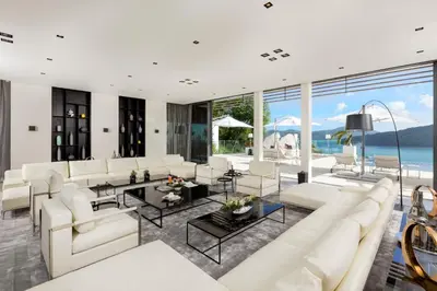 a living room with white furniture and a large window at Cliff Top Residence in Phuket Town