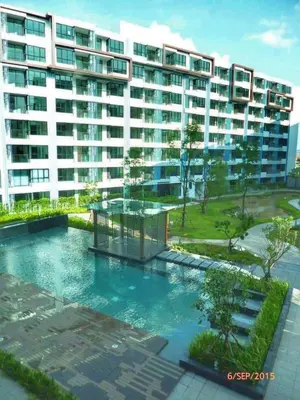 a building with a swimming pool in front of a building at Centrio 2 bed rooms in Phuket Town