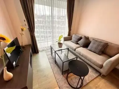 a living room with a couch and a table at Centrio 2 bed rooms in Phuket Town