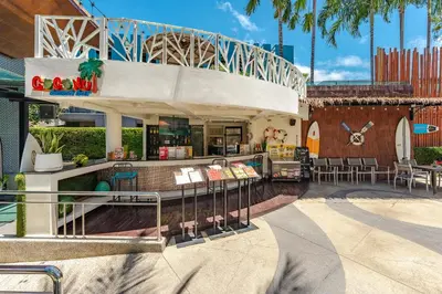 a restaurant with tables and chairs in a building at C202 Sun and Fun Kids Club 1BR 500m to Beach in Kata Beach