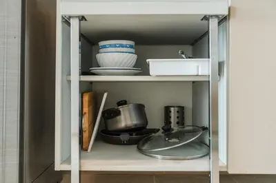a cabinet filled with dishes and bowls on a shelf at C203 Prime Area Near Beach, Dining & Shops in Bang Tao Beach
