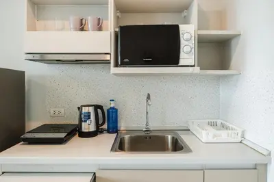 a kitchen counter with a sink and a microwave at C203 Prime Area Near Beach, Dining & Shops in Bang Tao Beach