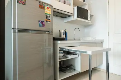 a kitchen with a stainless steel refrigerator and a counter at C203 Prime Area Near Beach, Dining & Shops in Bang Tao Beach