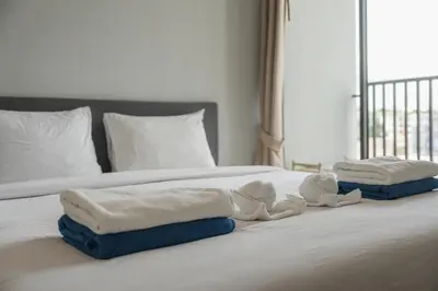 a bed with towels and stuffed animals on it at C203 Prime Area Near Beach, Dining & Shops in Bang Tao Beach