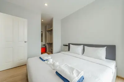 a bedroom with a white bed with towels on it at C203 Prime Area Near Beach, Dining & Shops in Bang Tao Beach
