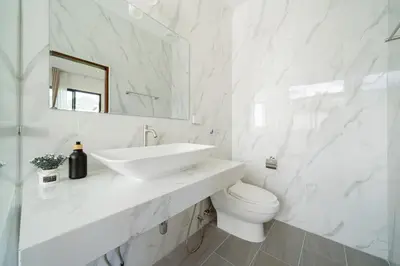 a white bathroom with a sink and a toilet at Kamala Sunshine Villa - Goldena Twin in Kamala Beach