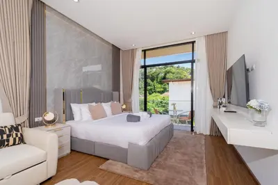a bedroom with a large white bed and a couch at Kamala Sunshine Villa - Goldena Twin in Kamala Beach