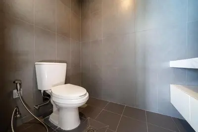 a bathroom with a toilet and a sink at Ocean Palms Private Pool Villas in Ban Thalat Choeng Thale