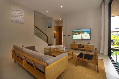 a living room with a couch and a tv at Chalong Bay View 3BR Pool Villa Long One B10 in Chalong