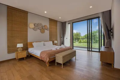 a bedroom with a large bed and a large window at Chalong Bay View 3BR Pool Villa Long One B10 in Chalong