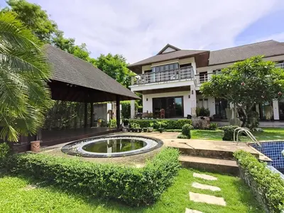 a house with a pond in the yard at Phu-Pha Thara Villa Phuket in Ban Saiyuan (1)