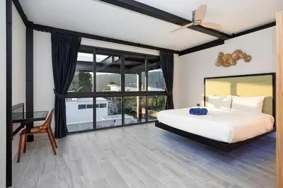 a bedroom with a bed and a large window at New 2-Storey Villa Sunset Garden 8 with 4BR & Eco-Pool, near Naiharn in Rawai Beach
