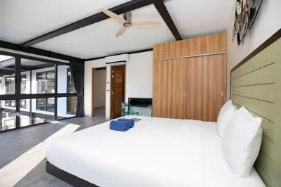 a bedroom with a white bed and a ceiling fan at New 2-Storey Villa Sunset Garden 8 with 4BR & Eco-Pool, near Naiharn in Rawai Beach