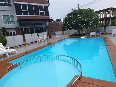 a large blue swimming pool in front of a building at The Sea Condo Ao Nang Apartment Relax with Sea View in Ban Khlong Haeng