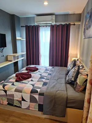 a bedroom with a large bed in front of a window at The Sea Condo Ao Nang Apartment Relax with Sea View in Ban Khlong Haeng
