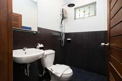 a bathroom with a toilet and a sink at Family 2BR Villa Lancelot 3 with Jacuzzi Pool, just 10 min drive NaiHarn and Rawai in Rawai Beach