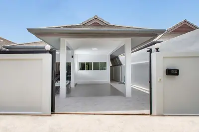 an open door of a house with a garage at Family 2BR Villa Lancelot 3 with Jacuzzi Pool, just 10 min drive NaiHarn and Rawai in Rawai Beach