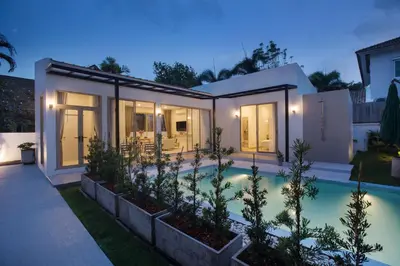 a house with a swimming pool at night at Your Tropical Island Home - New & Modern 2BR Pool Villa Seamate in Chalong