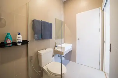 a bathroom with a toilet and a sink at Your Tropical Island Home - New & Modern 2BR Pool Villa Seamate in Chalong