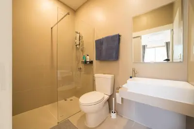 a bathroom with a toilet and a shower and a sink at Your Tropical Island Home - New & Modern 2BR Pool Villa Seamate in Chalong