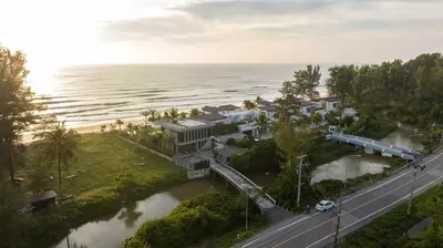an aerial view of a house next to the ocean at Luxury Beachfront Sea-View Retreat & Pool in Natai in Ban Na Tai