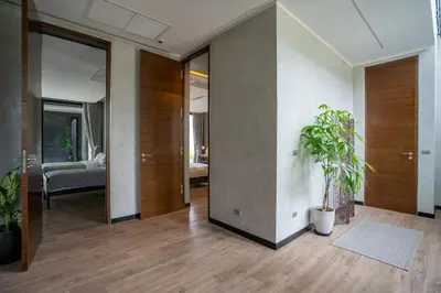 a living room with a hallway with a potted plant at Luxury Beachfront Sea-View Retreat & Pool in Natai in Ban Na Tai