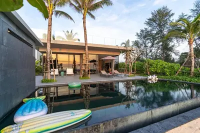 a house with a swimming pool and palm trees at Luxury Beachfront Sea-View Retreat & Pool in Natai in Ban Na Tai