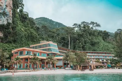 a building on a beach next to the water at Phi Phi Cliff Beach Resort in Phi Phi Don