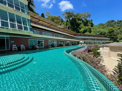 an empty swimming pool in front of a building at Phi Phi Cliff Beach Resort in Phi Phi Don