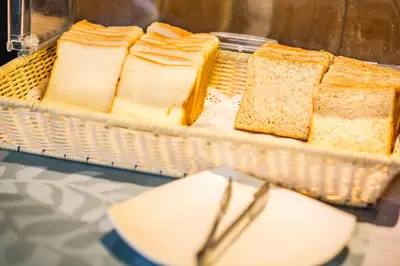 a basket of bread on a table with a plate at Phi Phi Cliff Beach Resort in Phi Phi Don