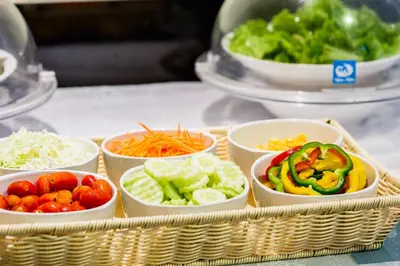 a tray filled with bowls of vegetables on a counter at Phi Phi Cliff Beach Resort in Phi Phi Don