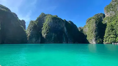 a view of a large body of water with mountains at Phi Phi Cliff Beach Resort in Phi Phi Don
