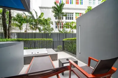 a balcony with a table and chairs and a tub at \u82ad\u4e1cThe DECK 6\u516c\u5bd3 \u8fd1\u82ad\u4e1c\u6d77\u6ee9BANGLA\u6c5f\u897f\u51b7 in Patong Beach