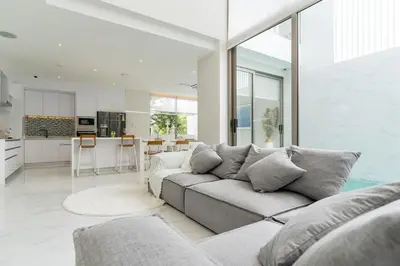 a living room with a couch and a kitchen at The Residence Tropical 3BR Villa with Private Pool in Ban Pak Lak